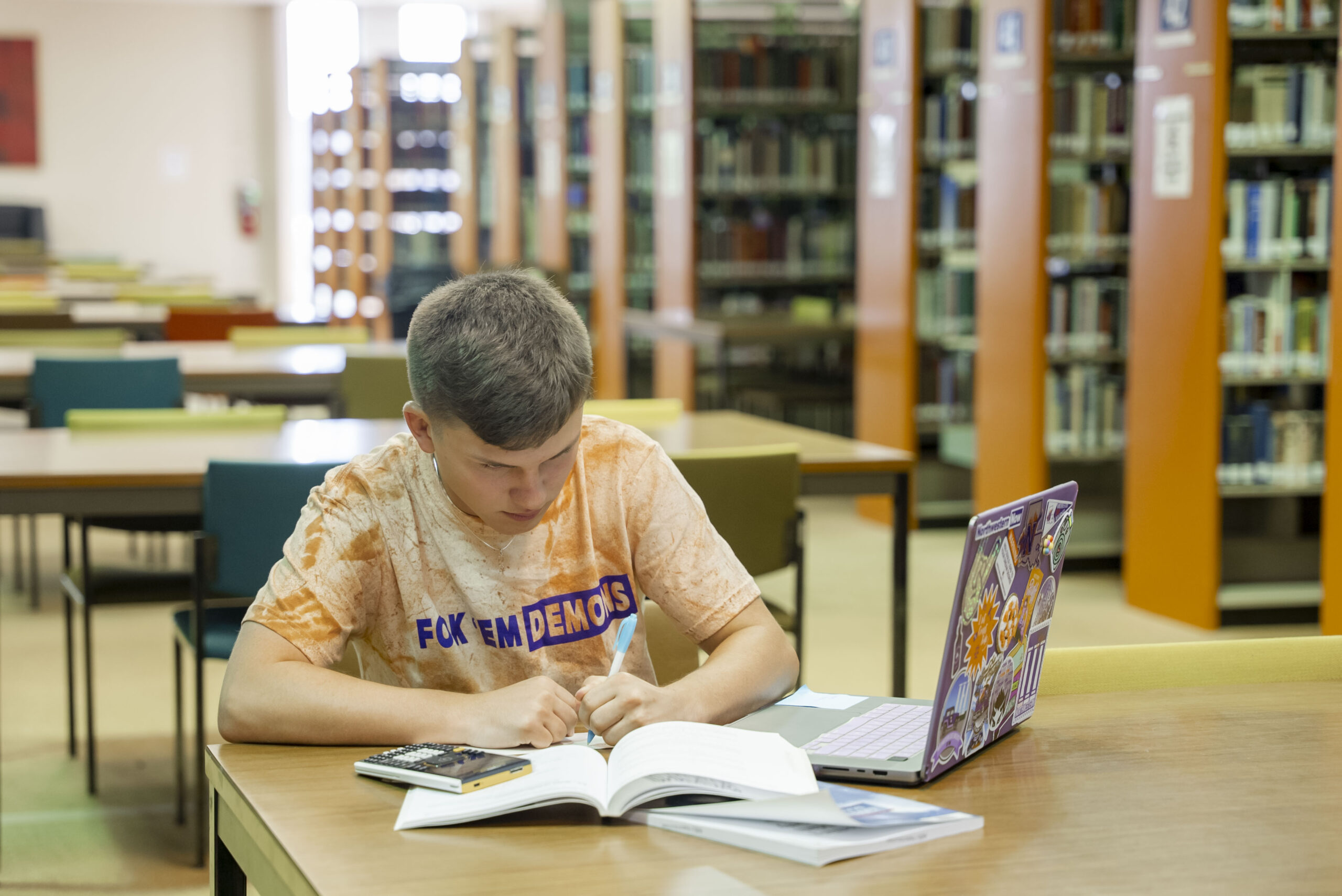 Student completing homework in the library