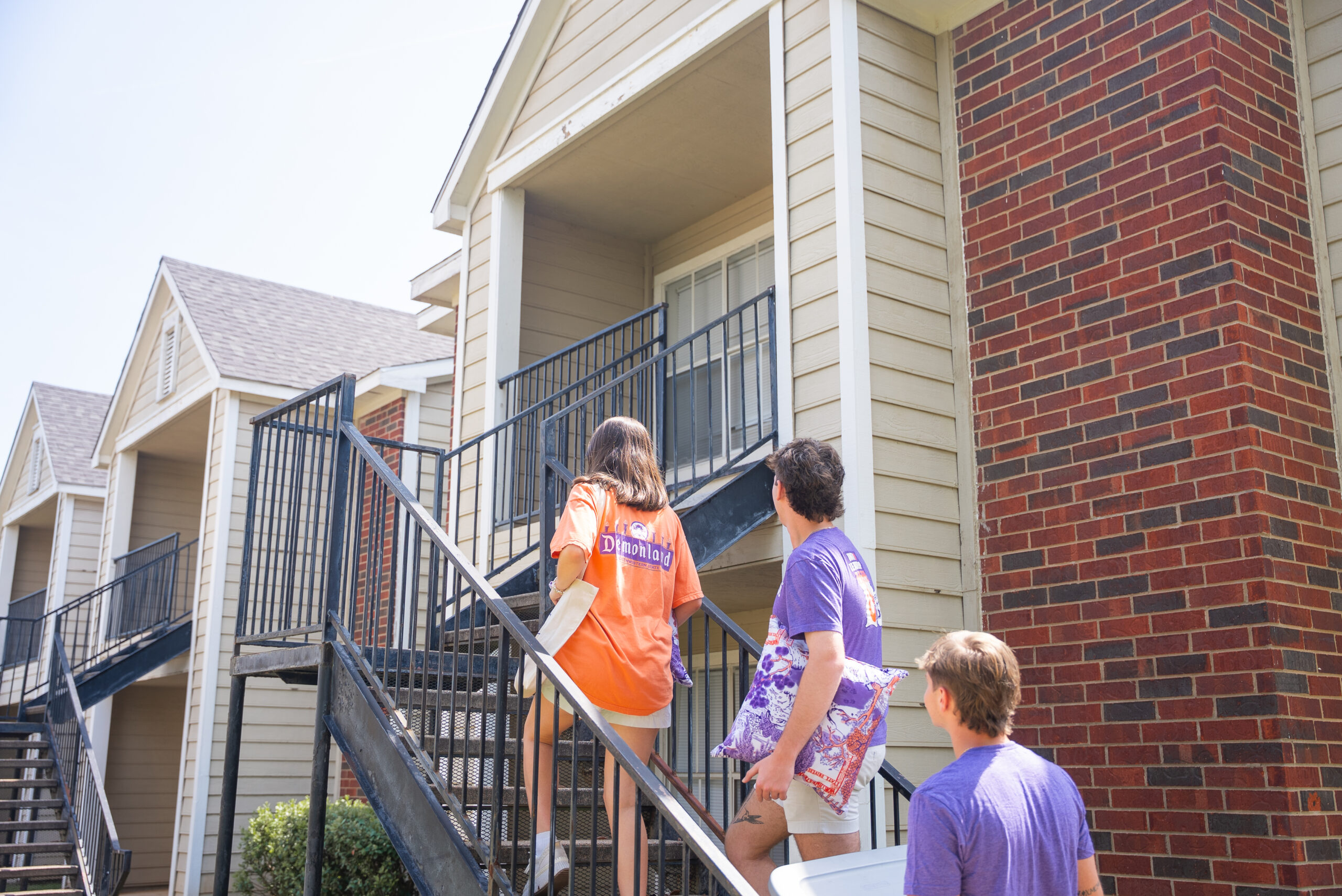 Students walking into dorm rooms on campus.