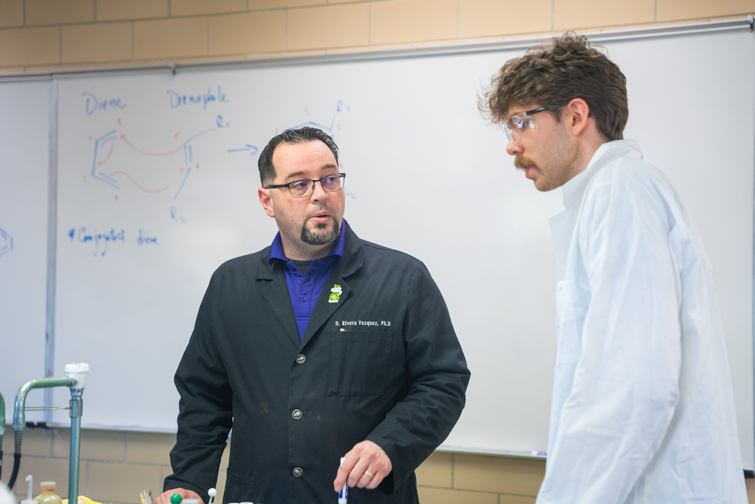 NSU instructor helps student during a chemistry lab