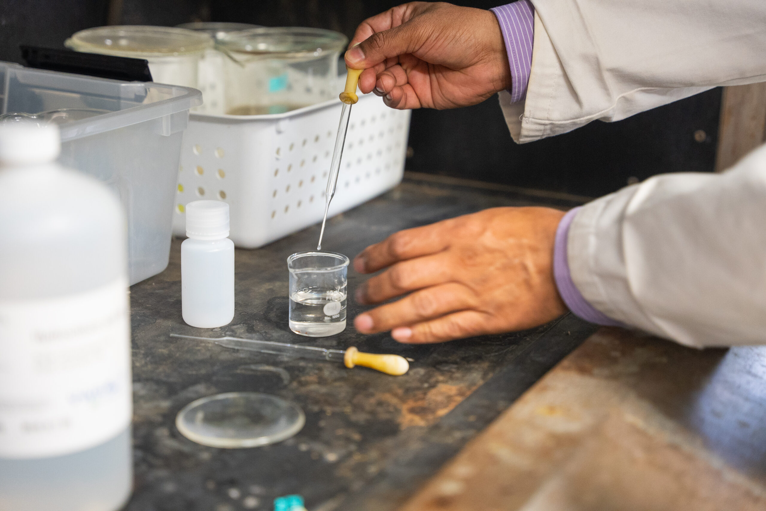 NSU instructor works with pipette and beaker