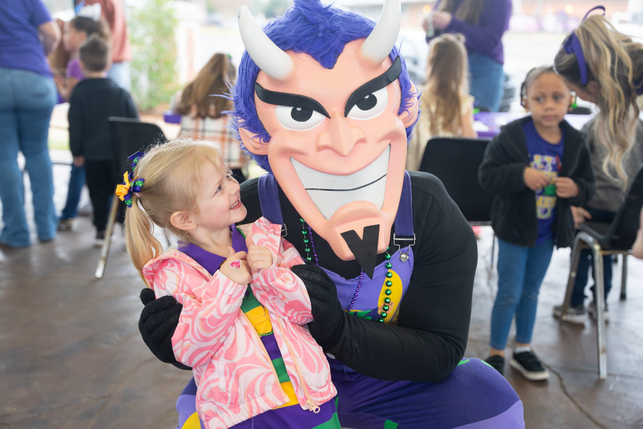Vic the Demon takes a photo with NSU Child Development Center student