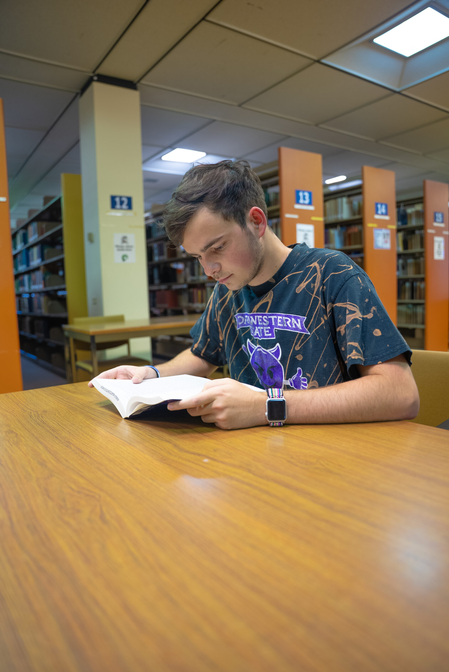 NSU student reads a book in the library