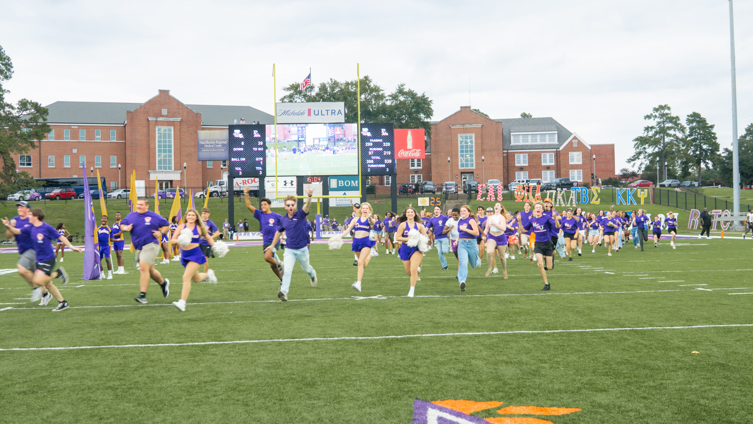 First-year students run across football field during Inferno Run