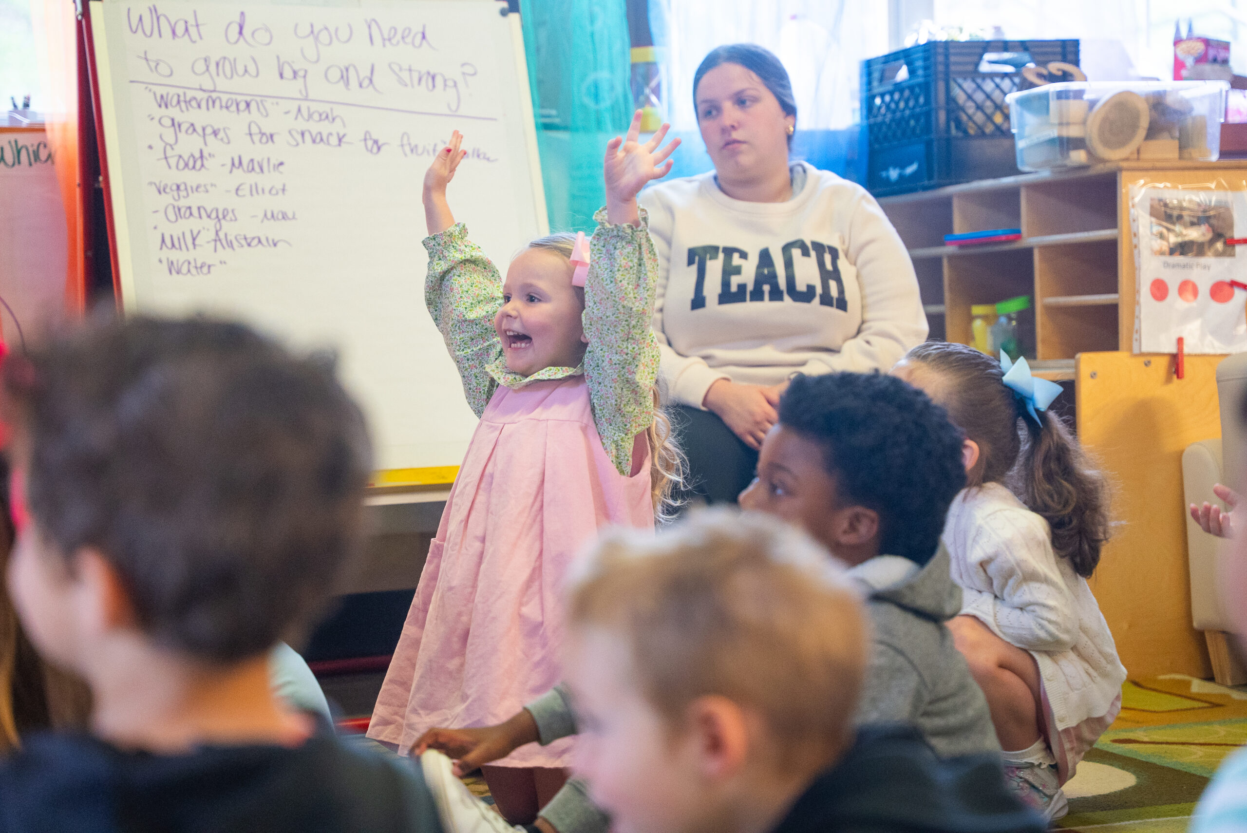 NSU Child Development Center student raises their hand with joy