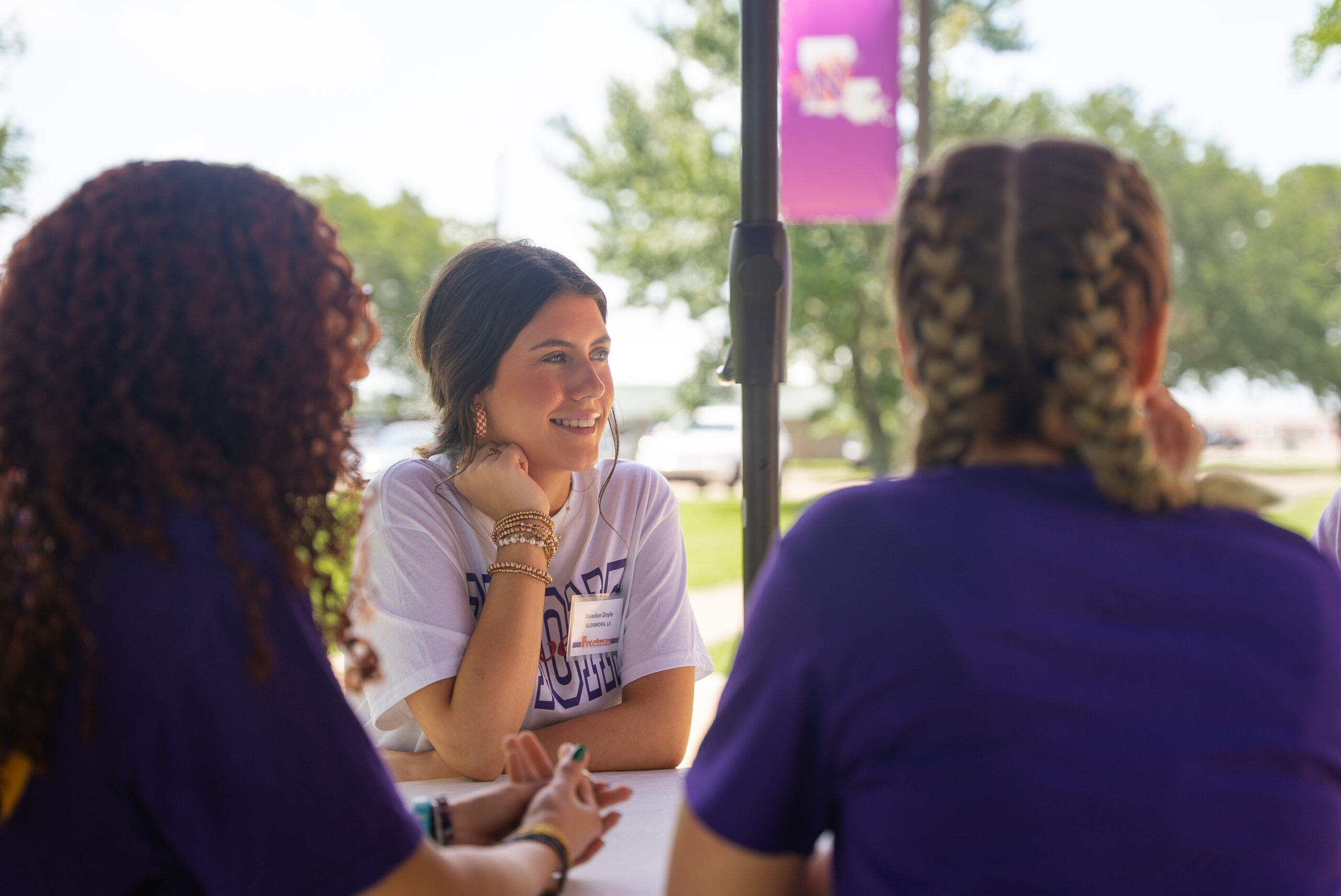NSU students sit at table outside