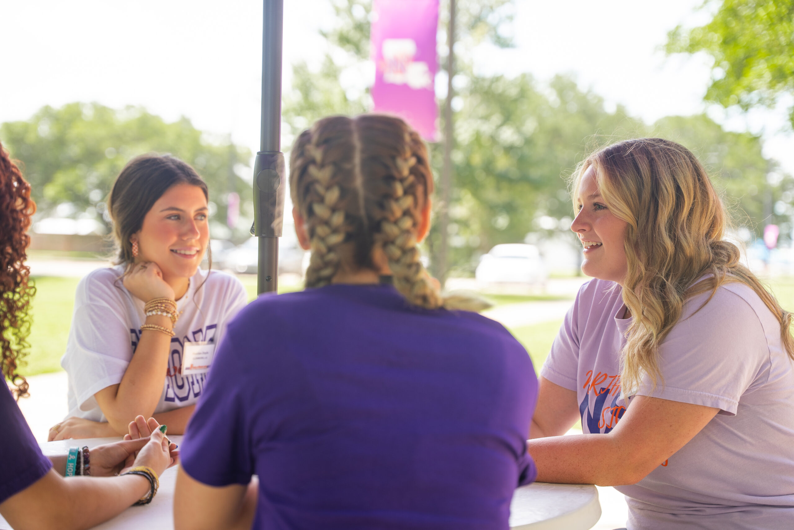 NSU students gather outside at a picnic table