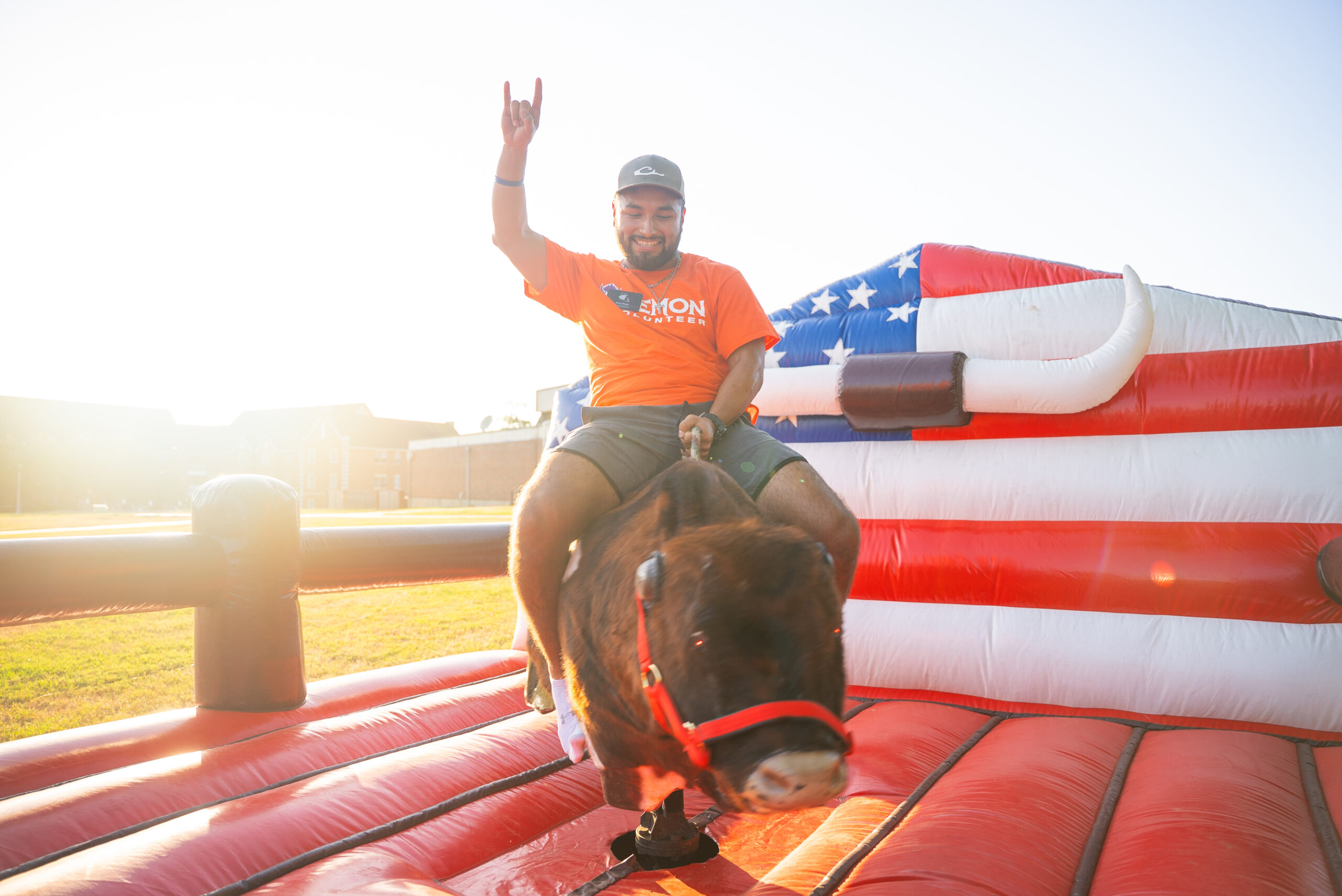 NSU student volunteer rides mechanical bull at Welcome Week event