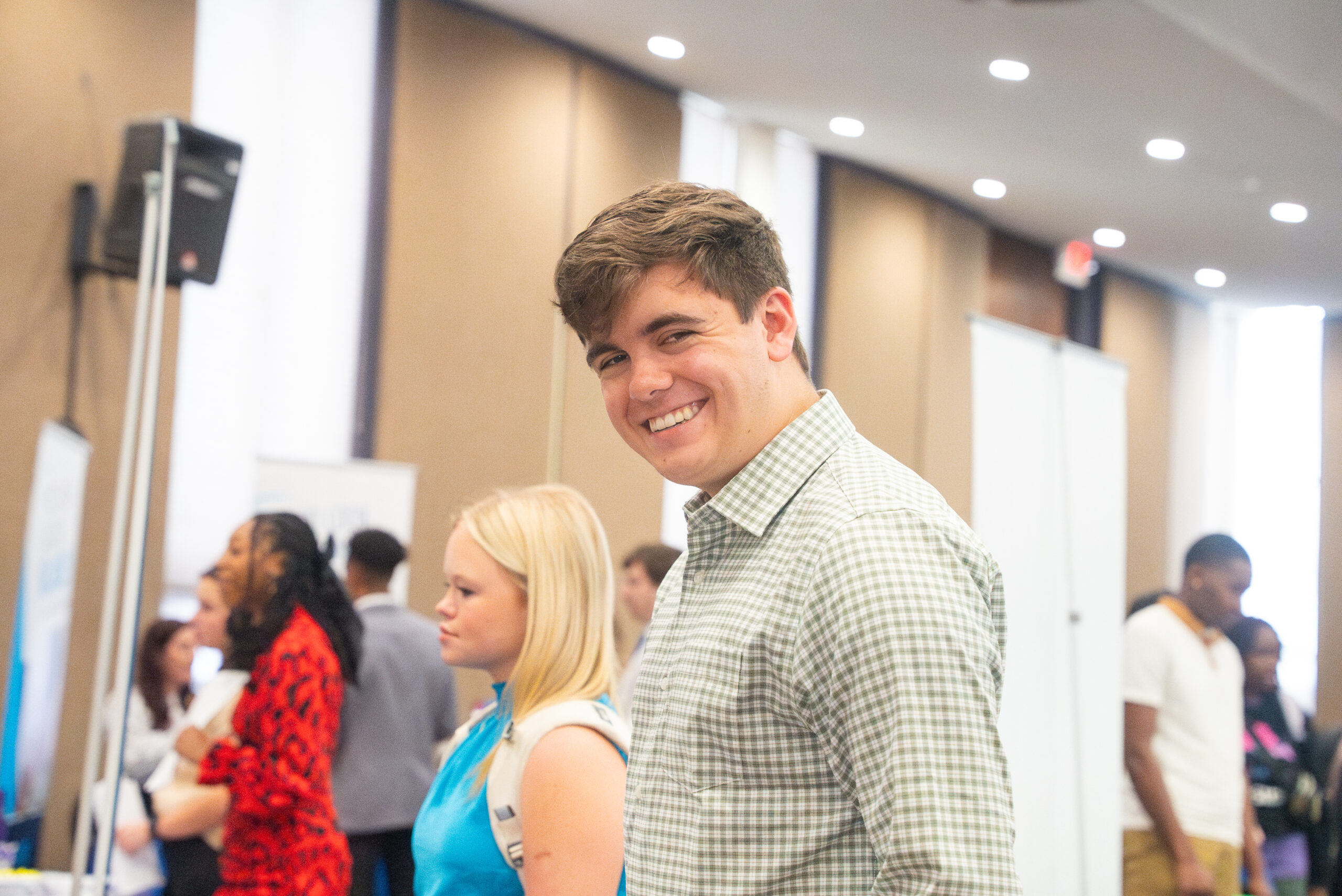 Students smiles while visiting with employers at the Career Fair