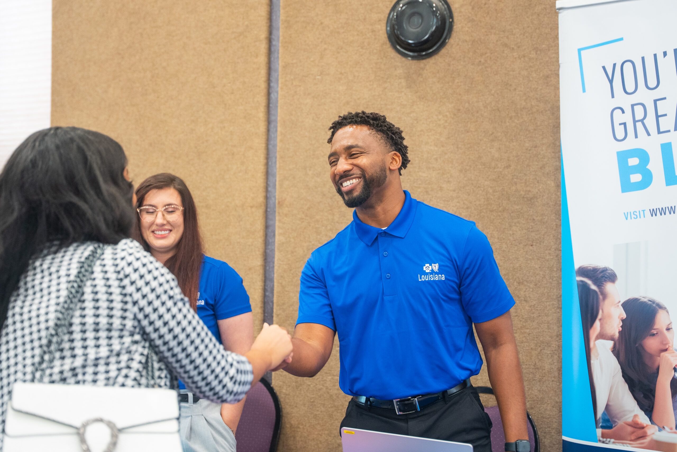 NSU alumnus greets student during Career Fair