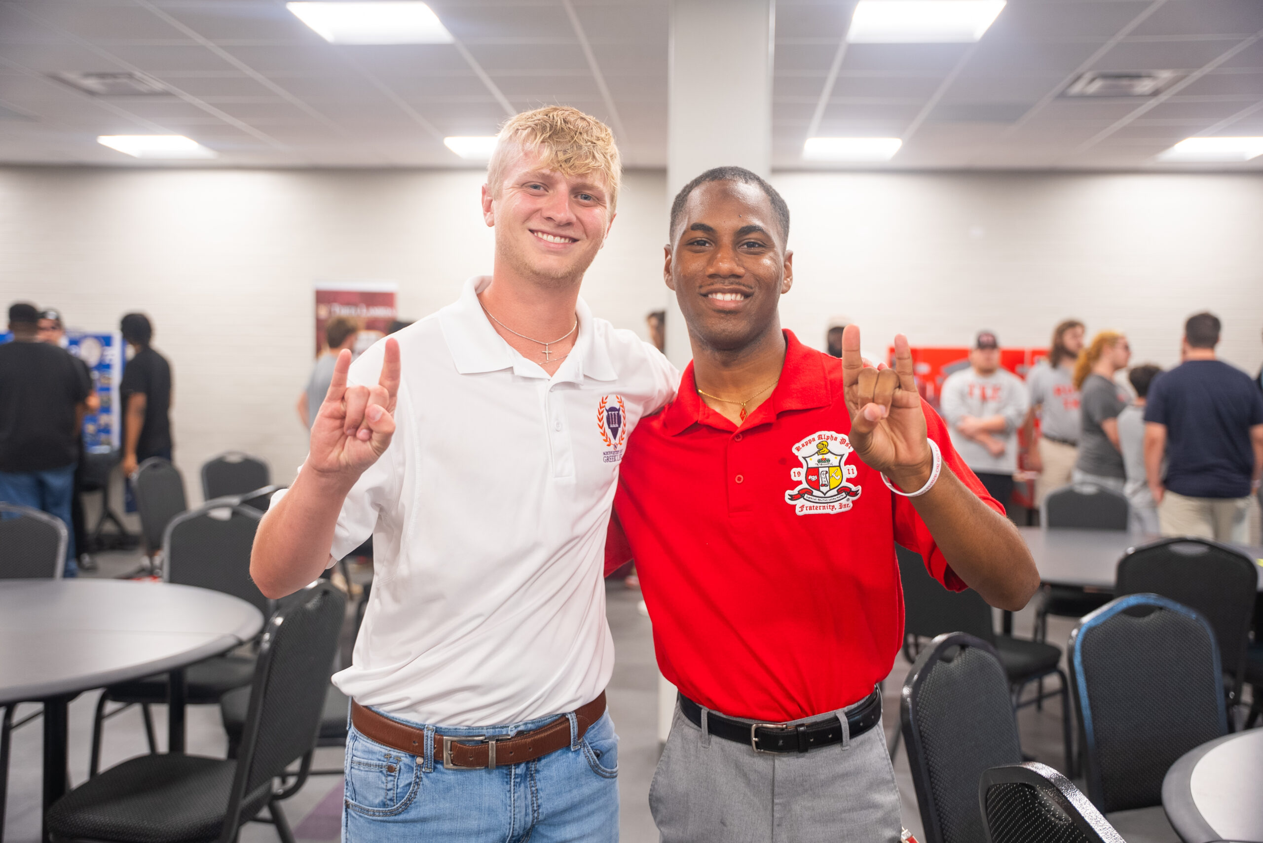 2 Greek students pose for a photo during a Greek informational event