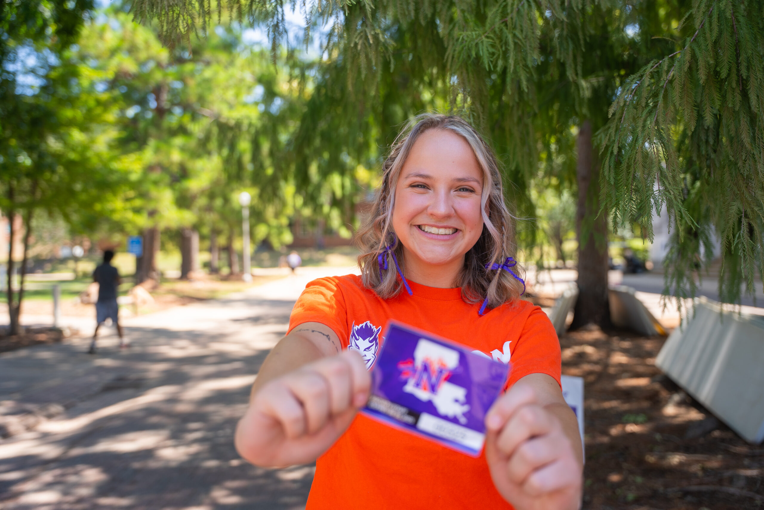 NSU student volunteer poses with a parking permit