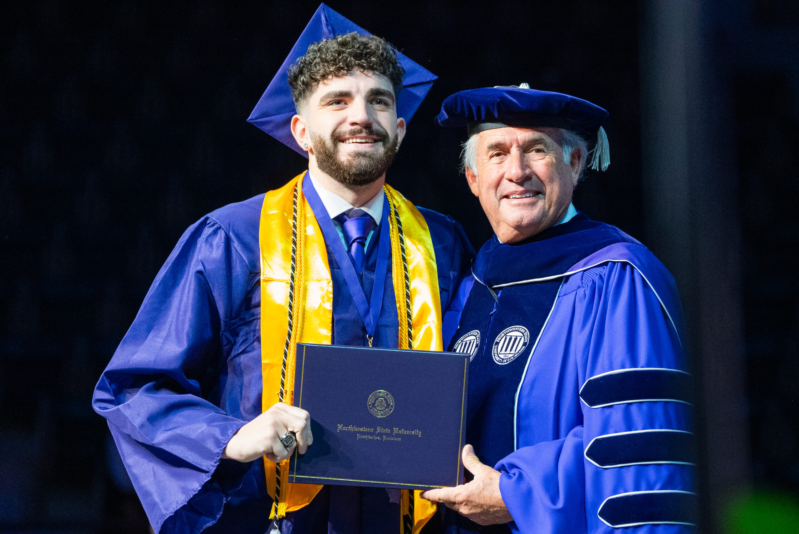 Criminal Justice graduate earn their degree on stage at commencement