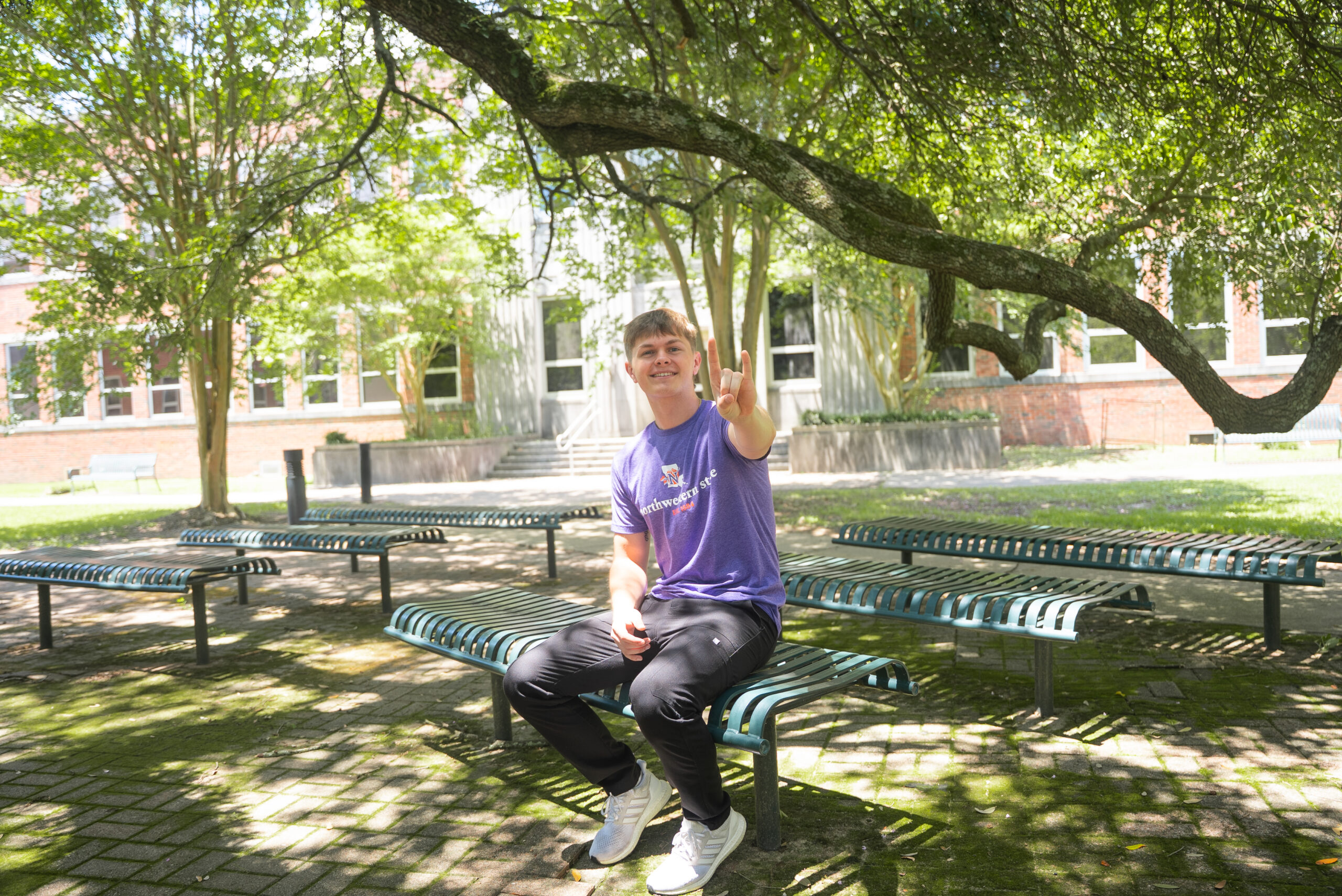 NSU Nursing student sits outside on campus