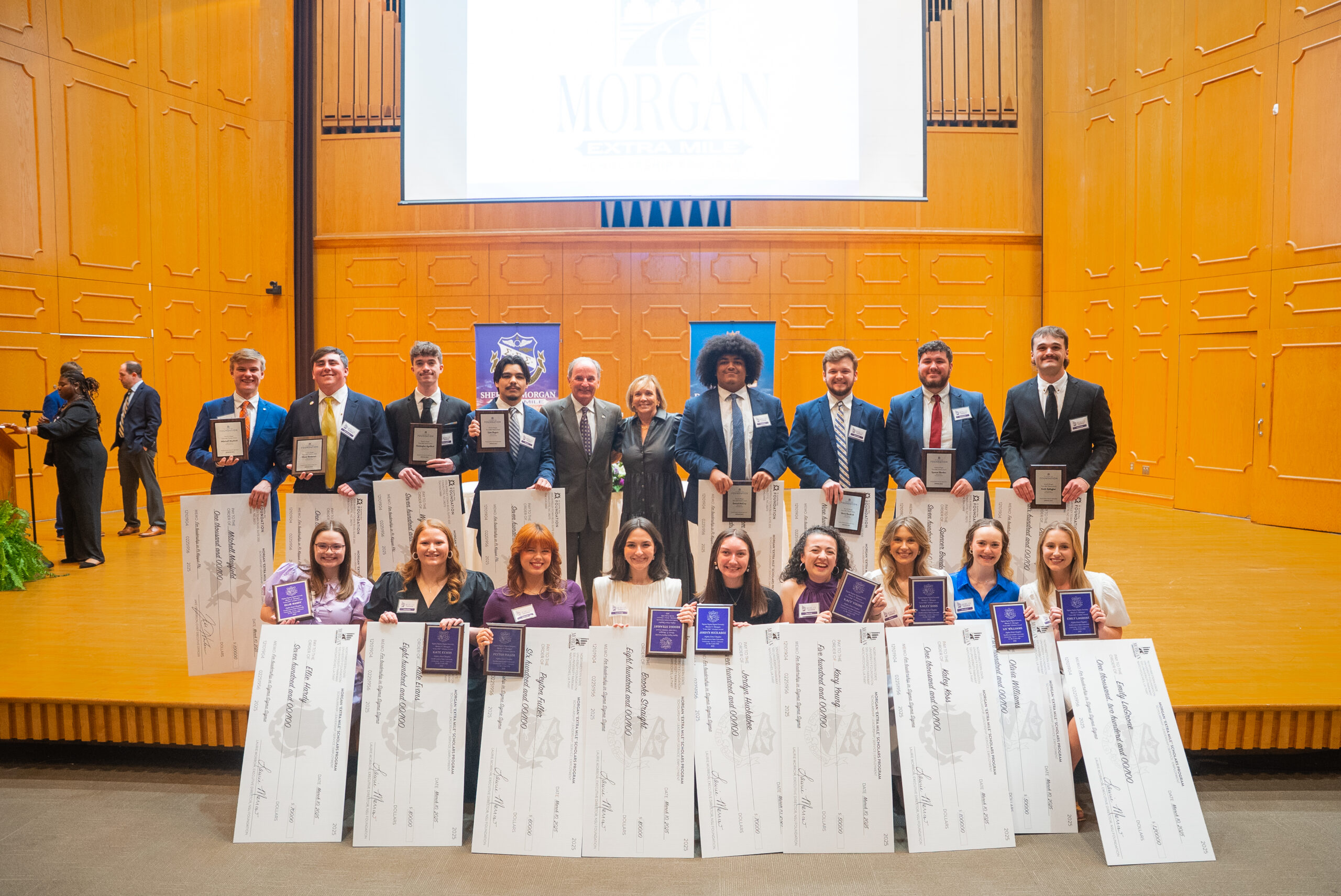 Scholarship recipients pose for a photo after being recognized