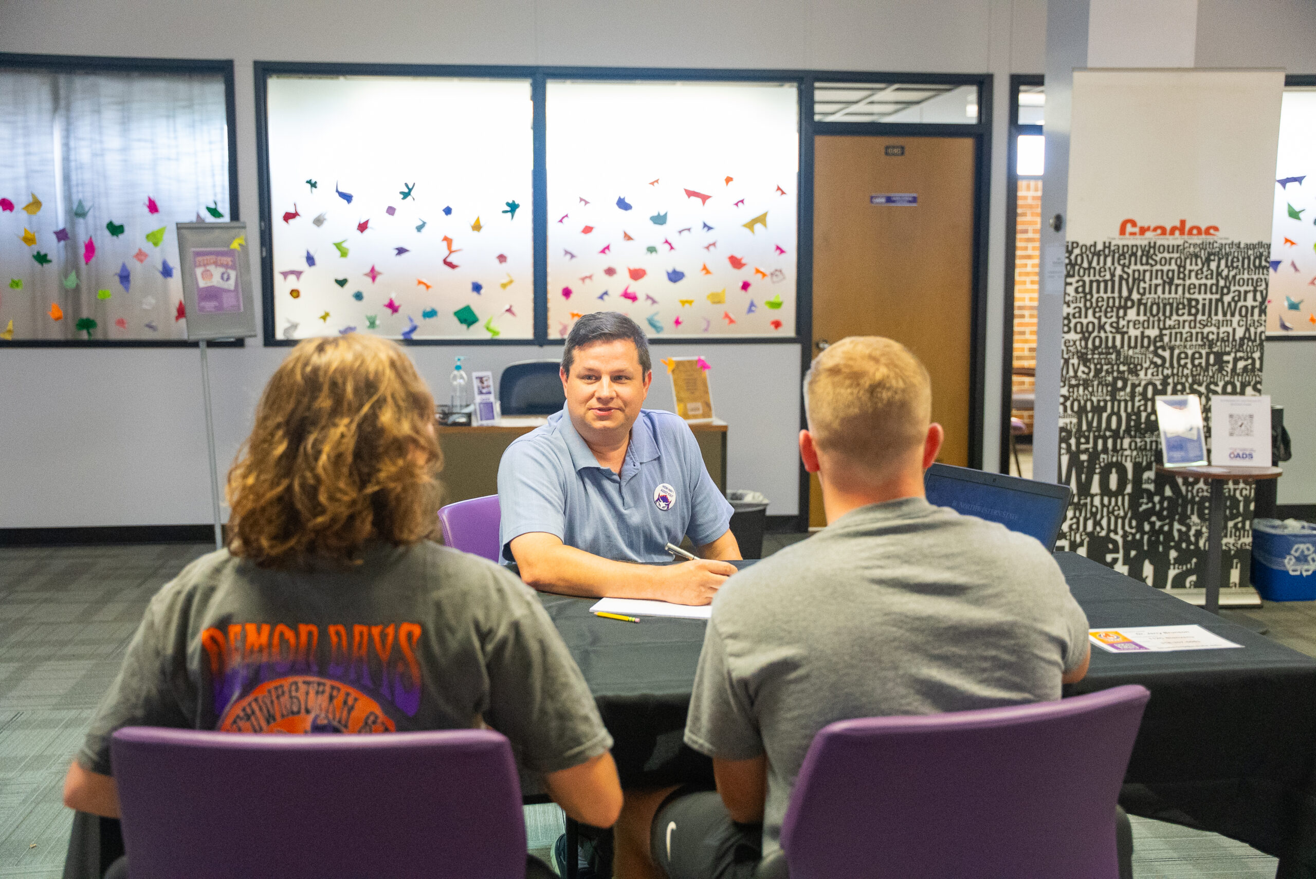 Instructor provides assistance to students in the library