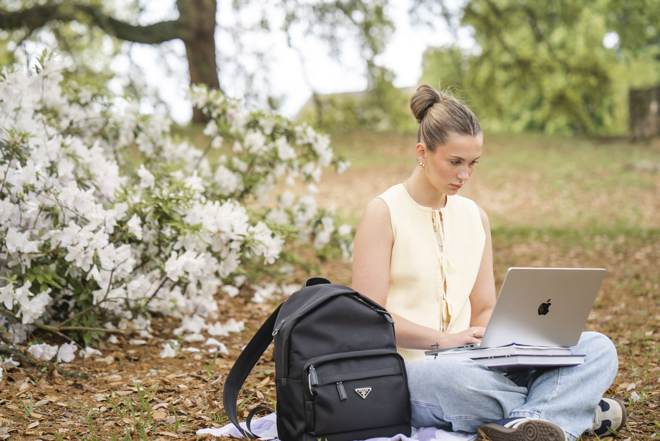 Student working on their laptop on campus