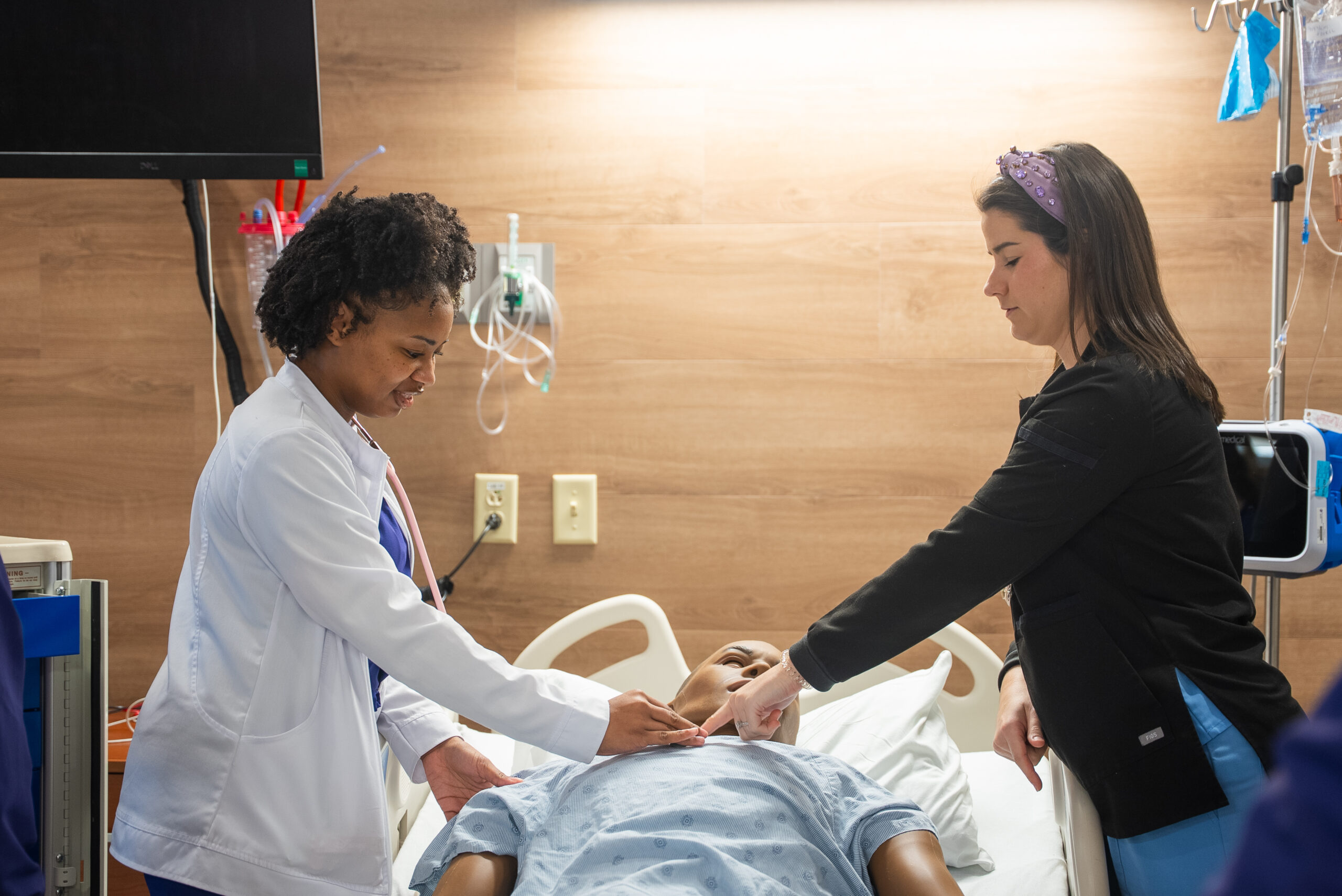 NSU nursing student checking pulse