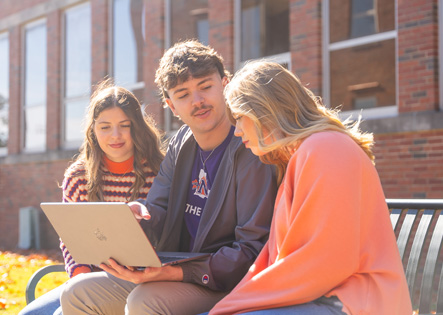 Three NSU students on bench at Fournet Hall