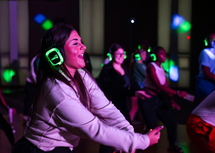 NSU student dancing at Glow Party Event during back to school bash.