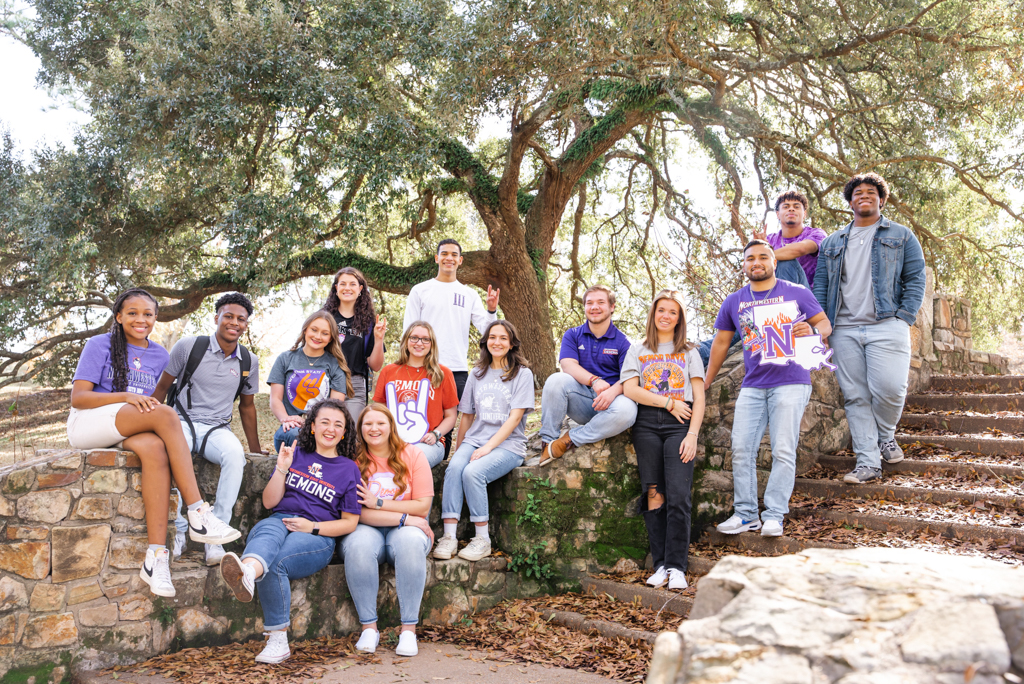 A group of NSU students pose for a photo on campus