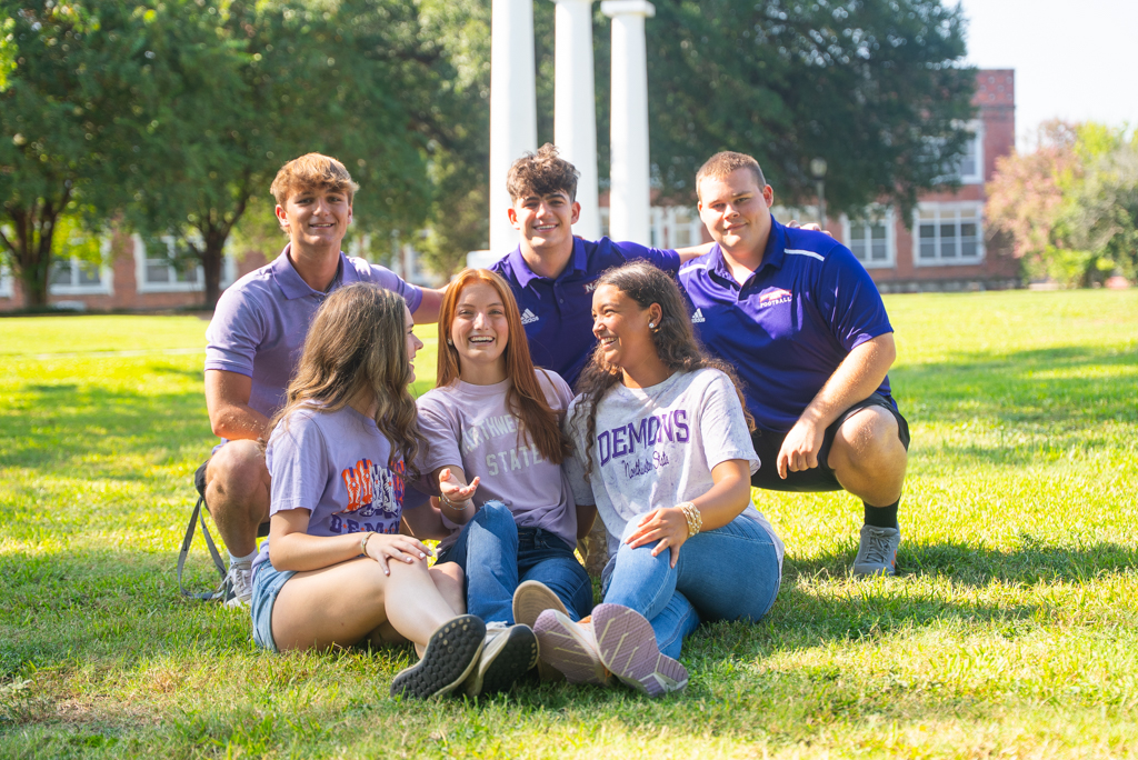 NSU Student Ambassadors sit on the lawn of Normal Hill