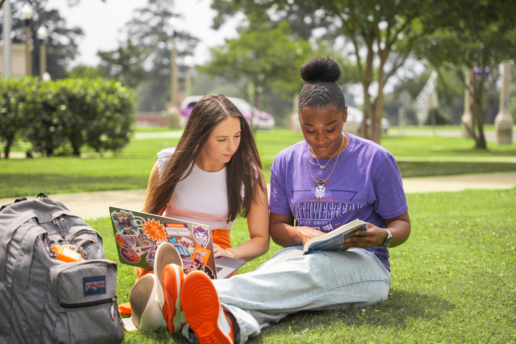 2 NSU students study in the lawn