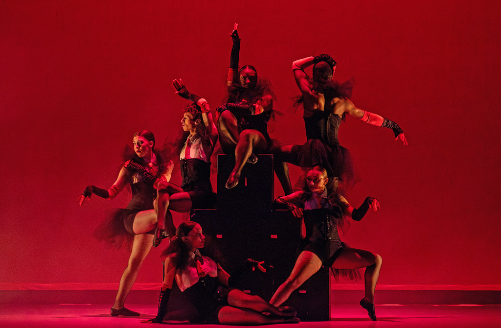 A group of NSU student dancers pose on a Theatre prop