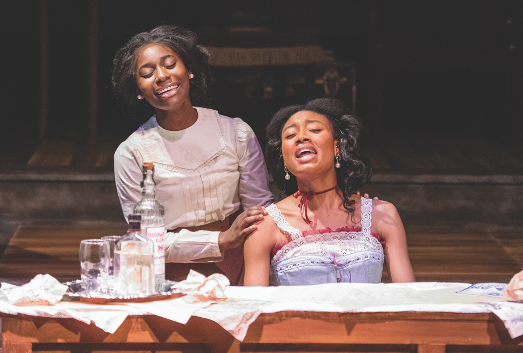 2 NSU Theatre students sing during a production