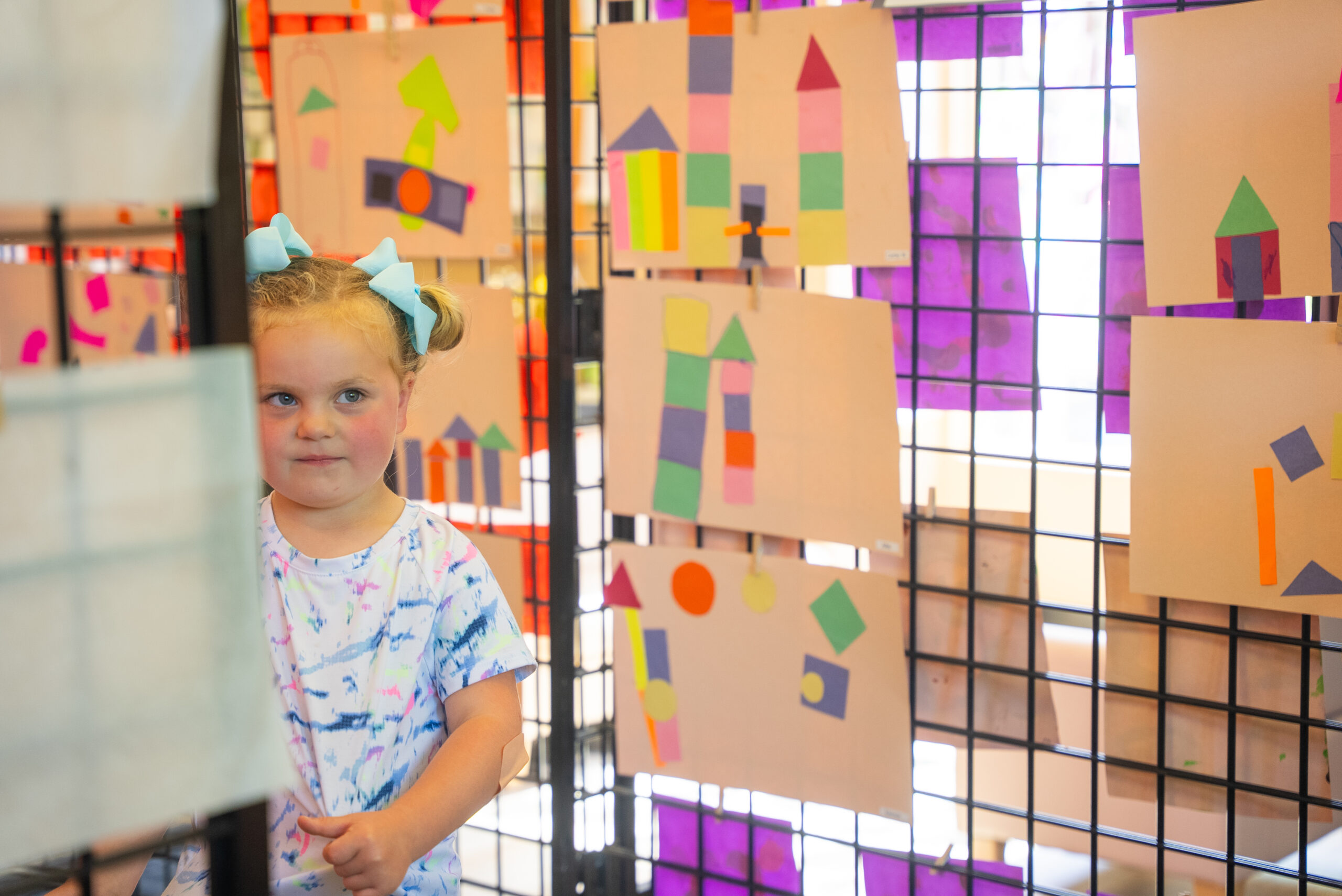Child standing in art exhibit