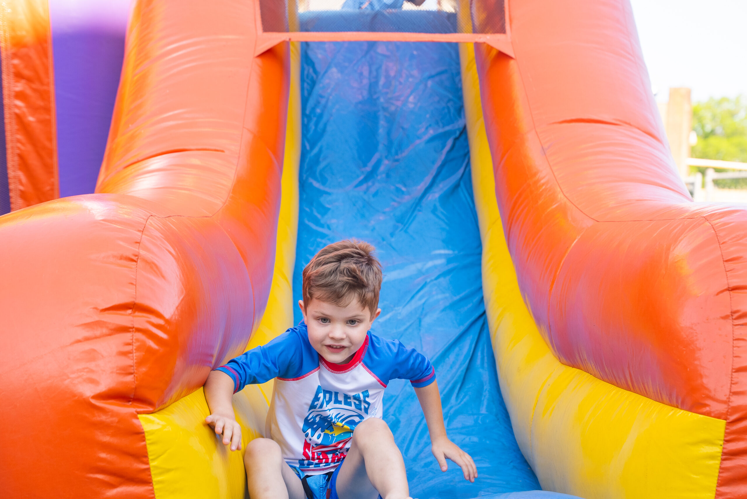 Child sliding down a waterslide.