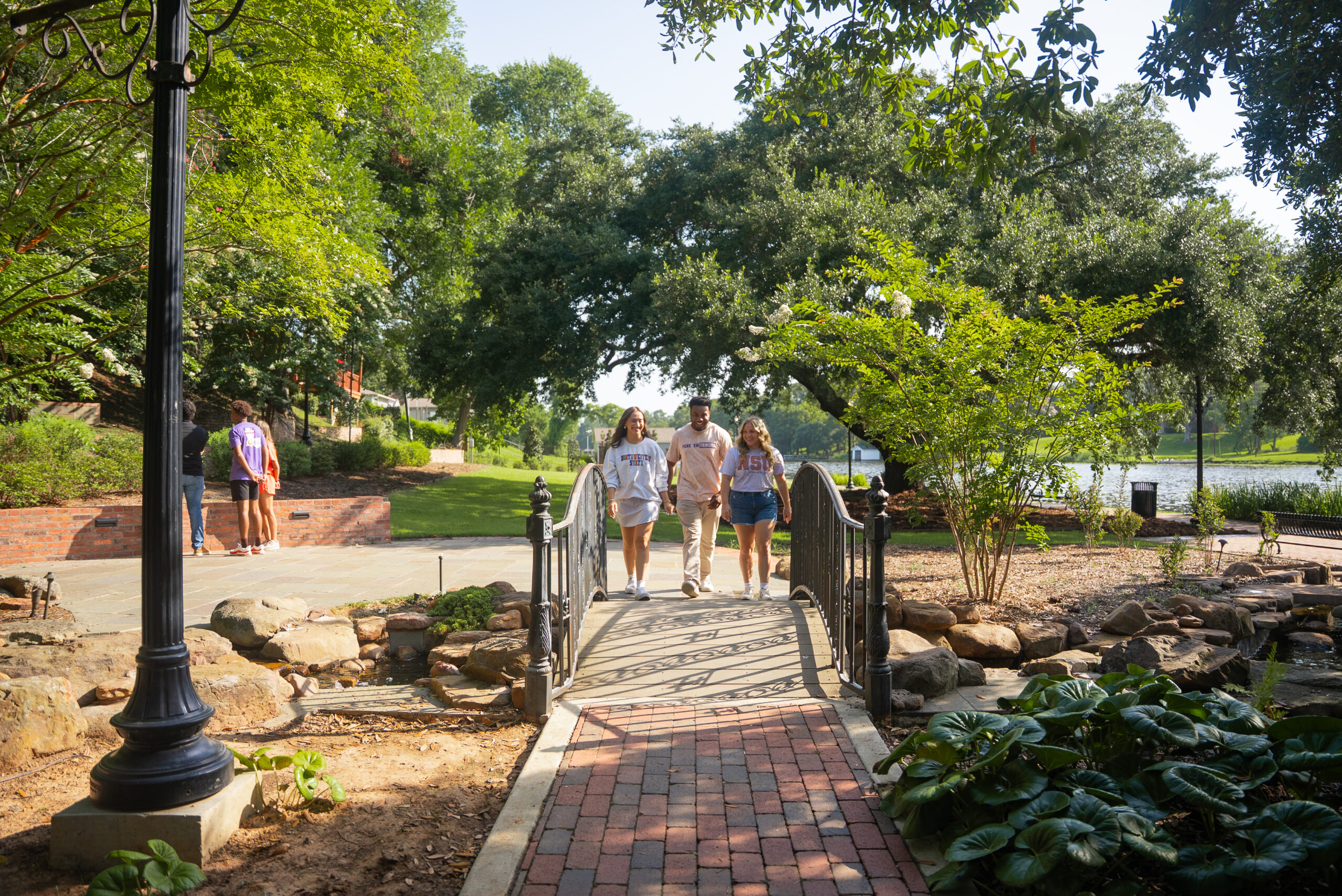 NSU students walking over a bridge in Natchitoches