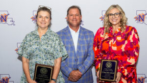Dr. Leslie Gruesbeck, left, and Dr. Kristen Walker Authement, right, were honored with Faculty Excellence in Academic Advising Awards. Steve Hicks, executive director of Academic Advising Services, center, presented the honors.