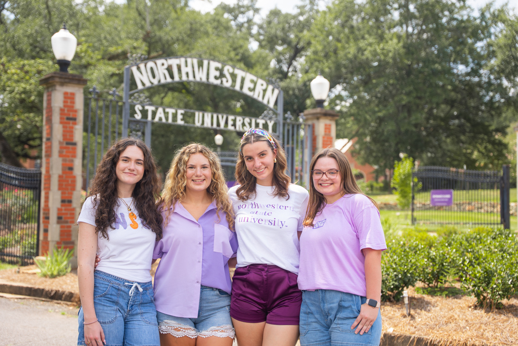 Northwestern State University gather in front of iconic front gates of Northwestern State University