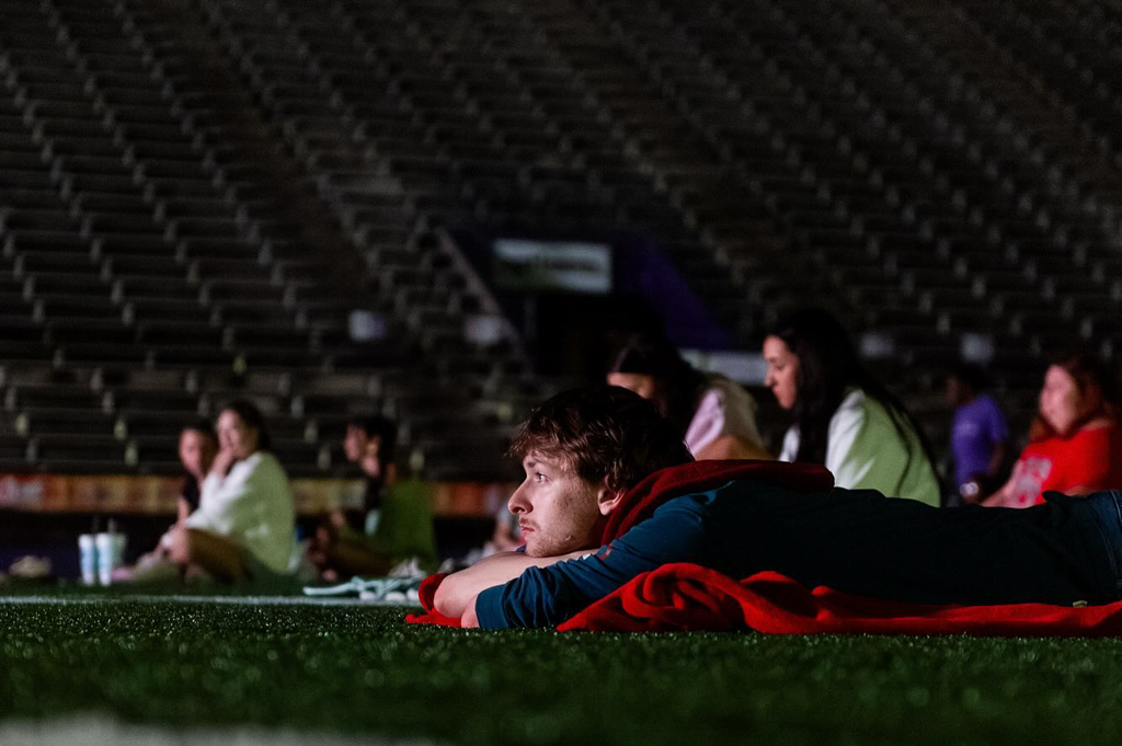 NSU students watching a movie on big screen at Turpin Stadium