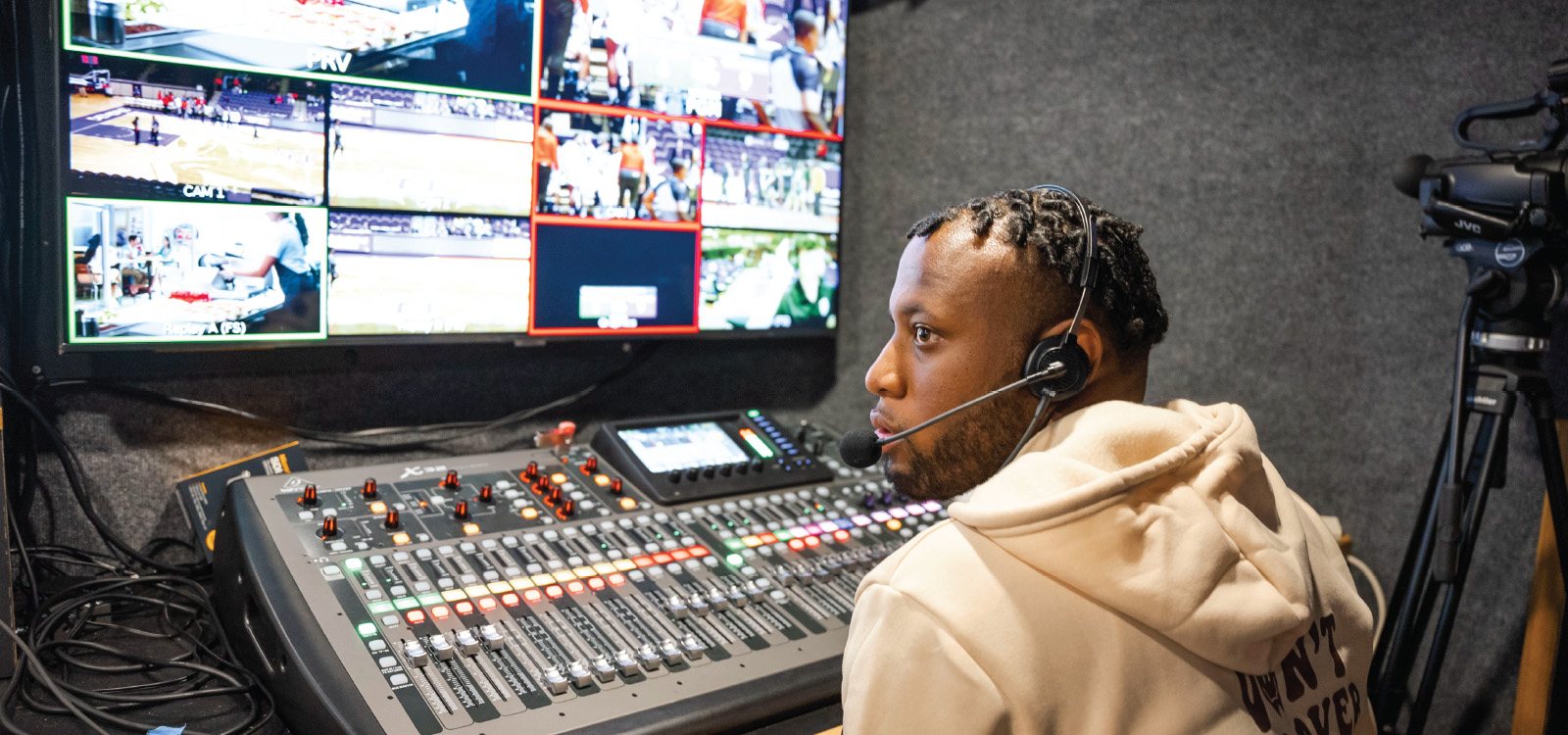 NSU student in production trailer covering ESPN+ producing.