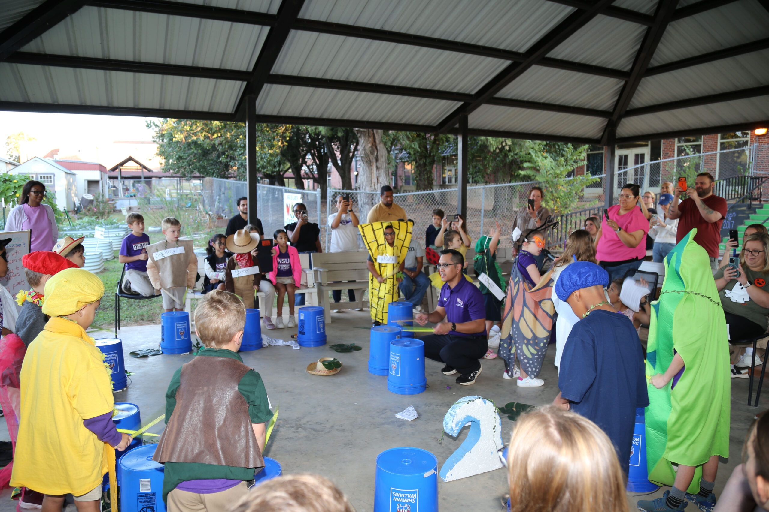 NSU Associate Professor Percussion Oliver Molina, father of NSU Elementary Lab first grader Elliott Molina, accompanied singers on bucket drums to perform “Grow, Grow, Little Seed” during “Garden Adventure” Reader’s Theatre.