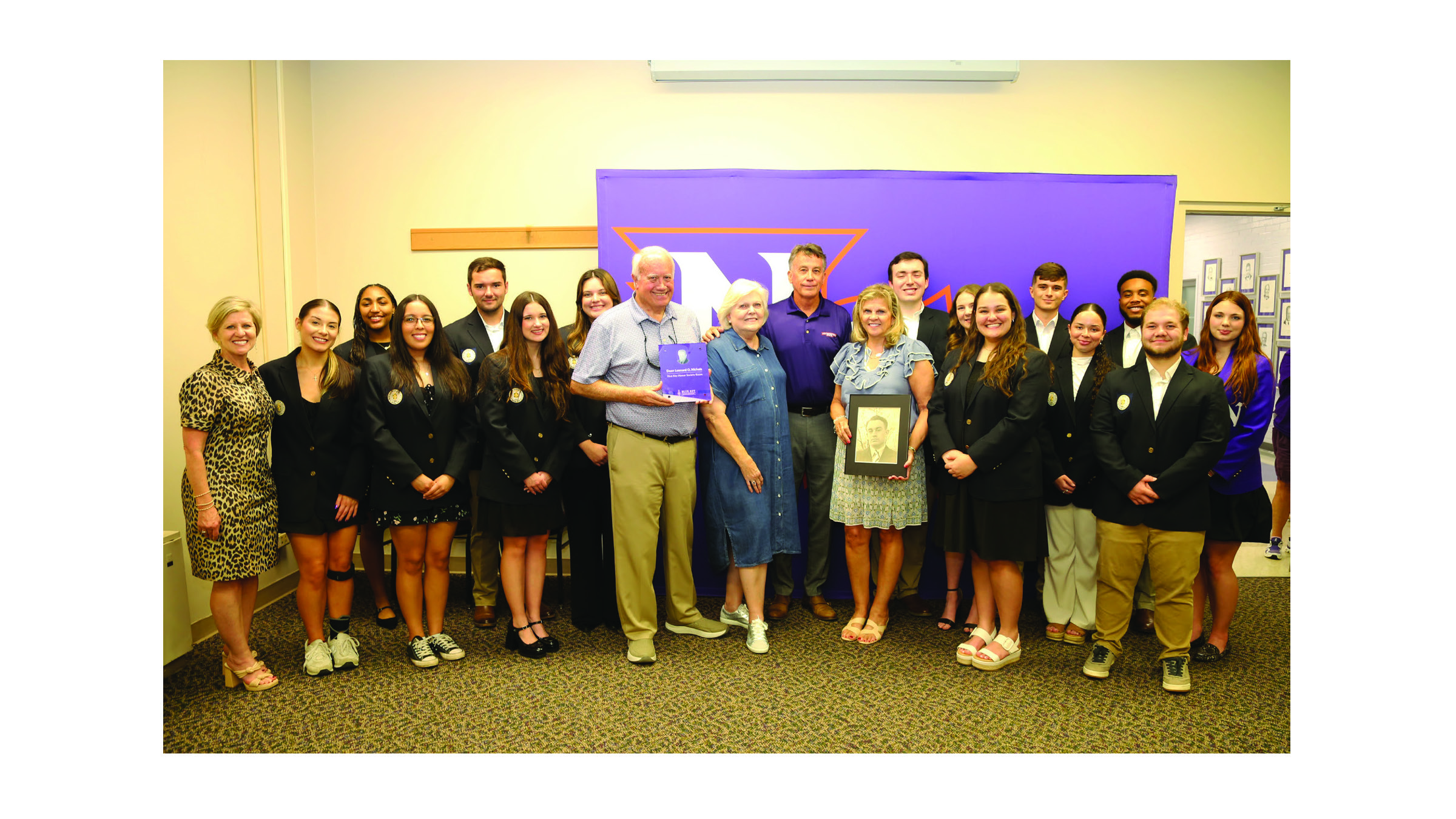 Student Union Room 221 will henceforth be known as the Dean Leonard O. Nichols Blue Key Honor Society Room following a dedication program Oct. 3. From left are Dean of Students Reatha Cox, Blue Key members Nicole Miller, Jayda Gee, Alonda Torres, Chapter President Christopher Richard, Abigail Petermann, SGA President Madysen Morgan, family members J. Larry Kees, Rhonda Kees, Lynn Kees and Lori Kees, Eli Dyjack, Caroline Blanchard, Paige Lindsey, Alex Laurent, Alyssa Austin, Christian James, Bryce Juneau and Callie McDowell.