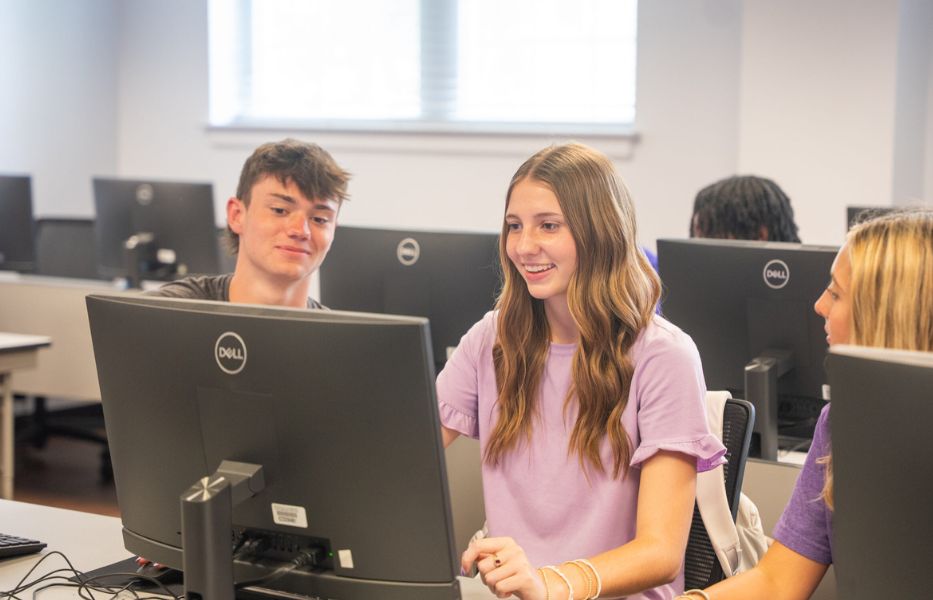 Students looking at computer.