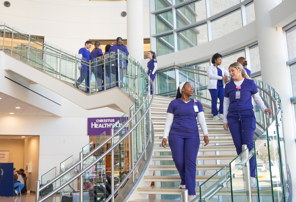 NSU Nursing students walking down stairs at Cabrini Health in Alexandria, LA