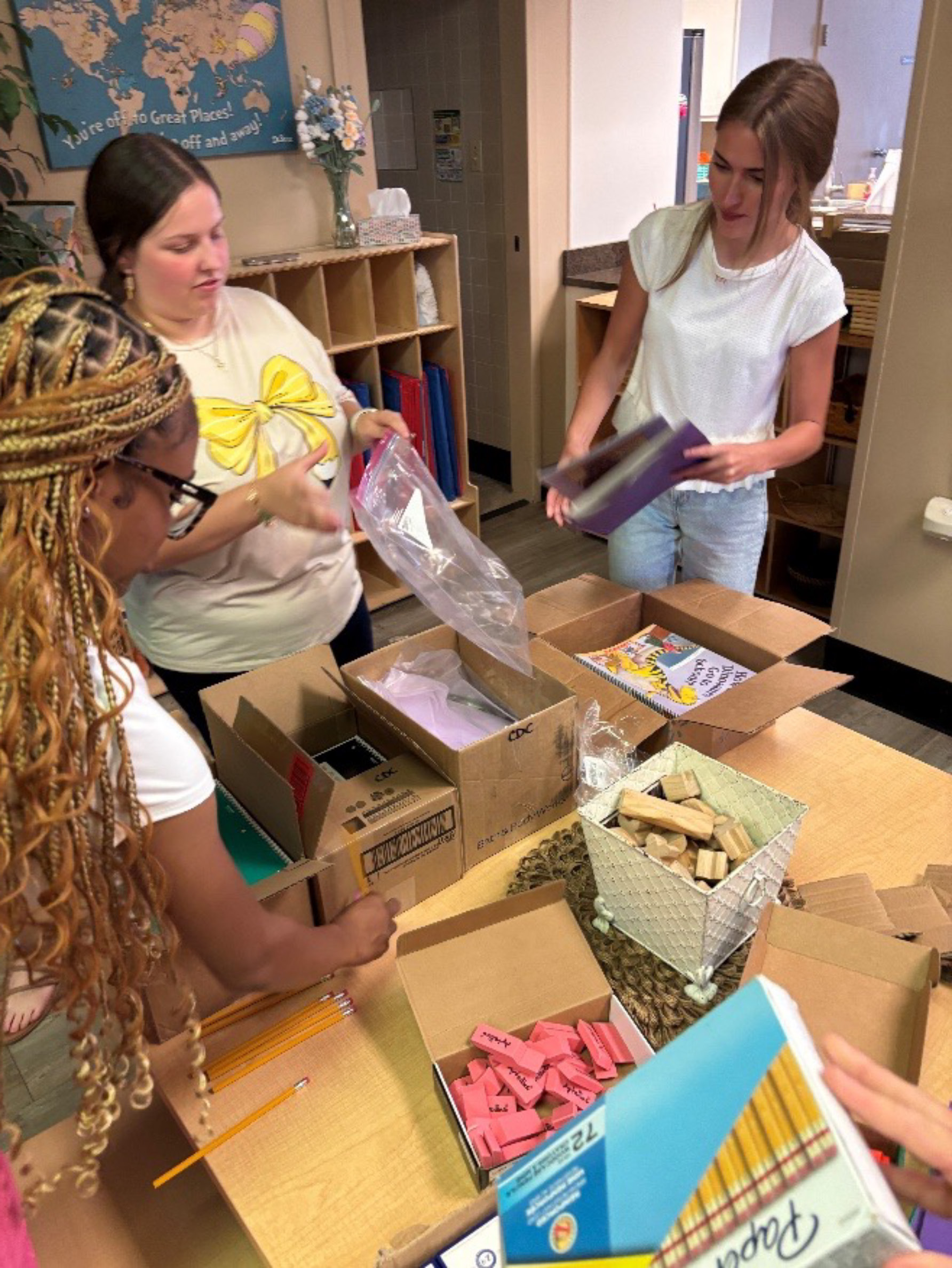 NSU Early Childhood Education and Child and Family Studies majors Aryannah Allen, Rylee Adams, and Emma Grace Wilson gather materials for family literacy bags.