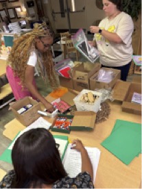 NSU Early Childhood Education and Child and Family Studies students Natalia Olvera, Aryannah Allen and Rylee Adams assemble family literacy bags. 