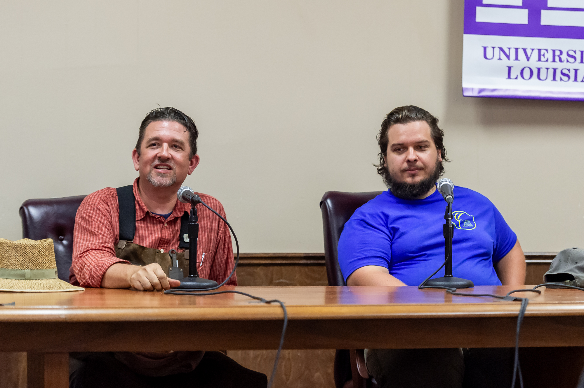 People speaking at the Louisiana Studies Conference into a microphone