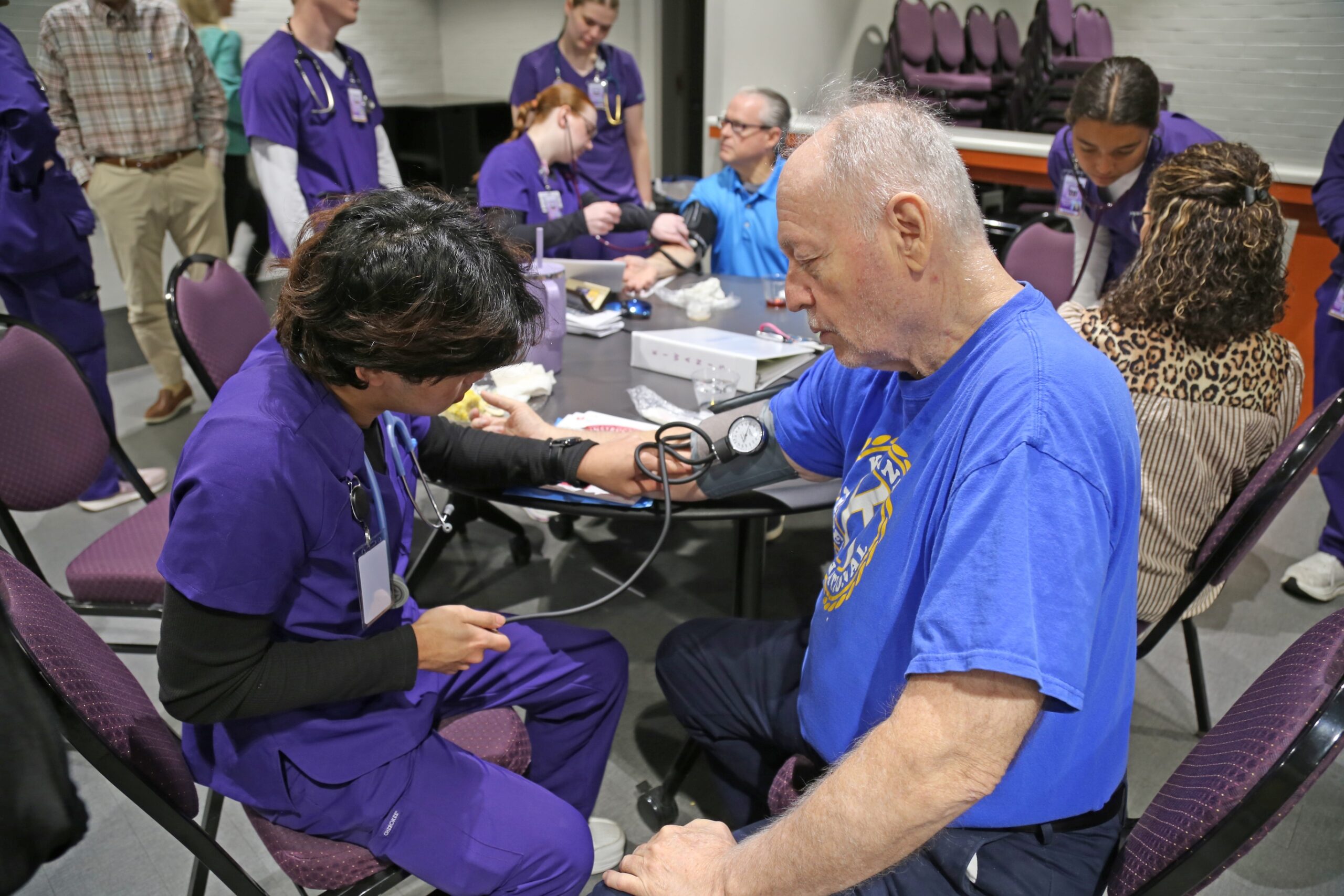 NSU nursing student Ruben Kho of Alexandria checked Don Barker’s blood pressure following a Demons Engage presentation for the Kiwanis Club on March 12.