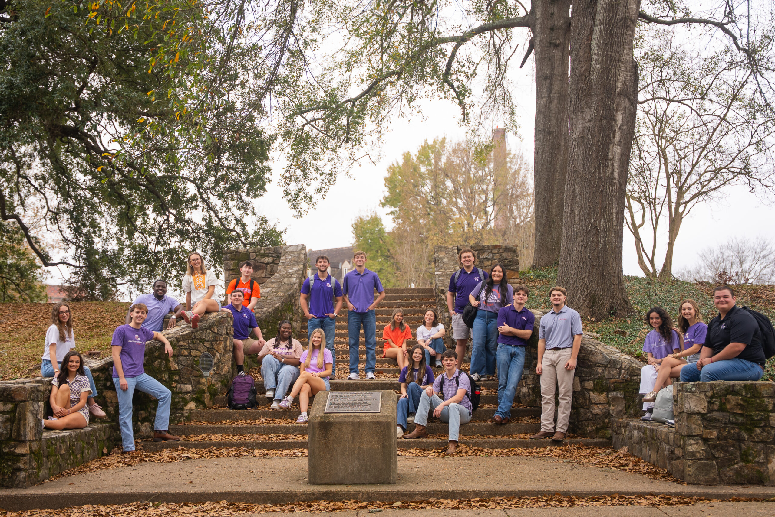 Group of students sitting on stairs on campus