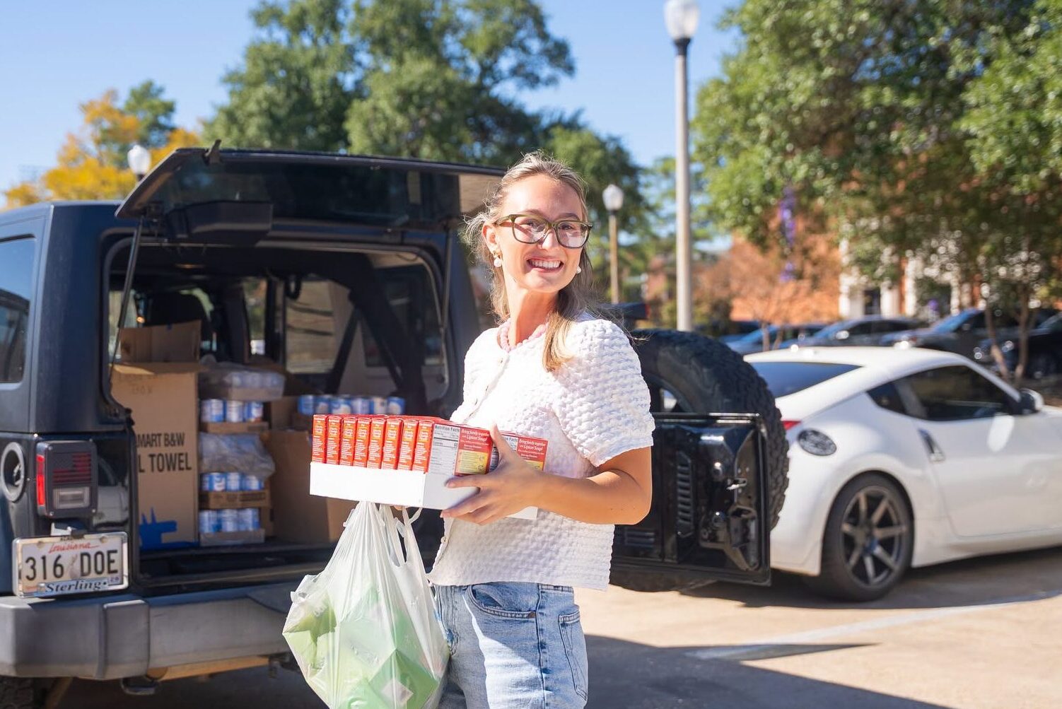 Northwestern State University Homecoming Queen Reese Kennedy carries donated food items during NSU’s Homecoming food drive benefiting the NSU Food Pantry.