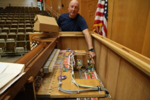 Organ Master JR Neutel showed the inside of pipe organ console where a nest of wires has been replaced with state of the art digital components.