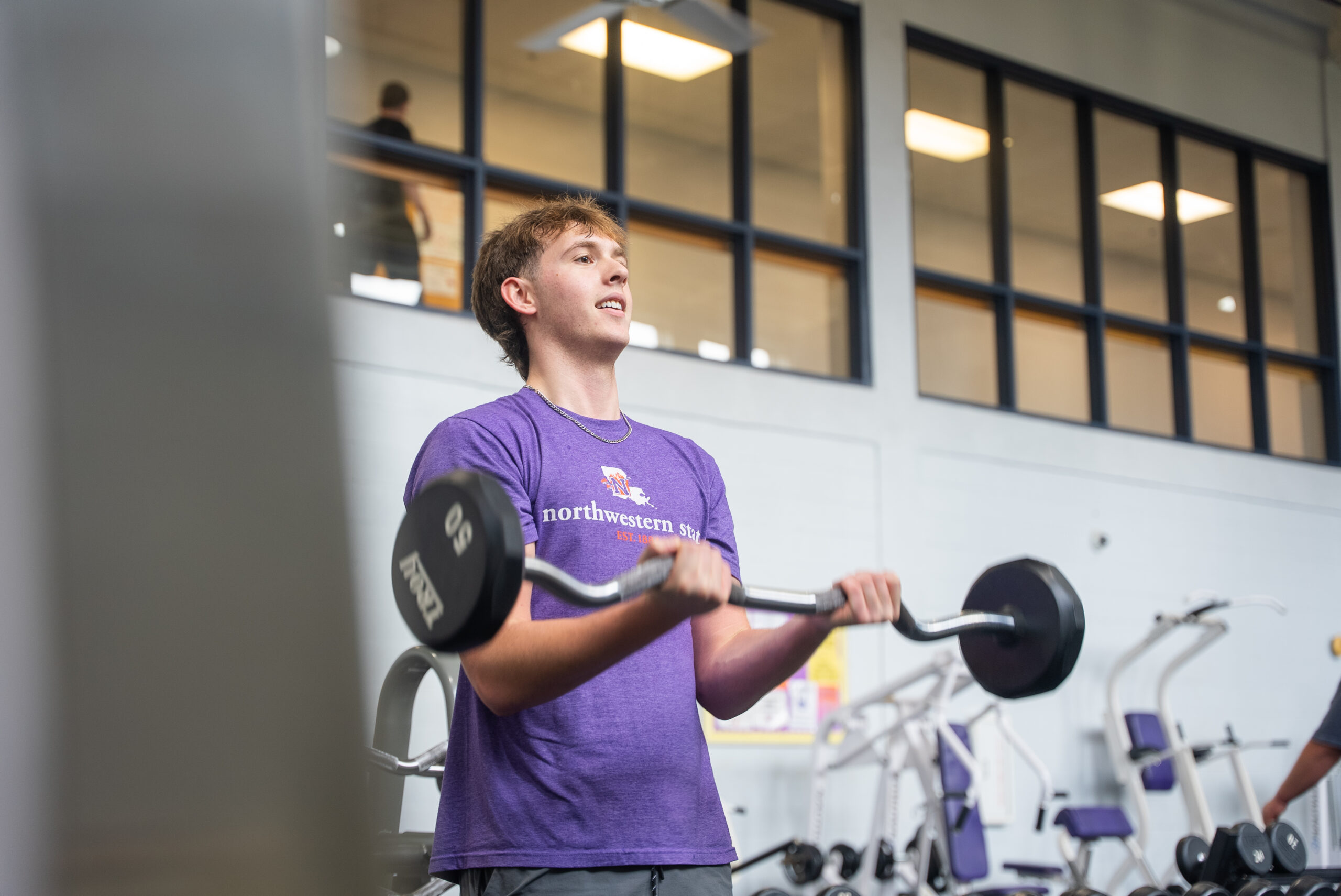 NSU Student lifting weights at the gym