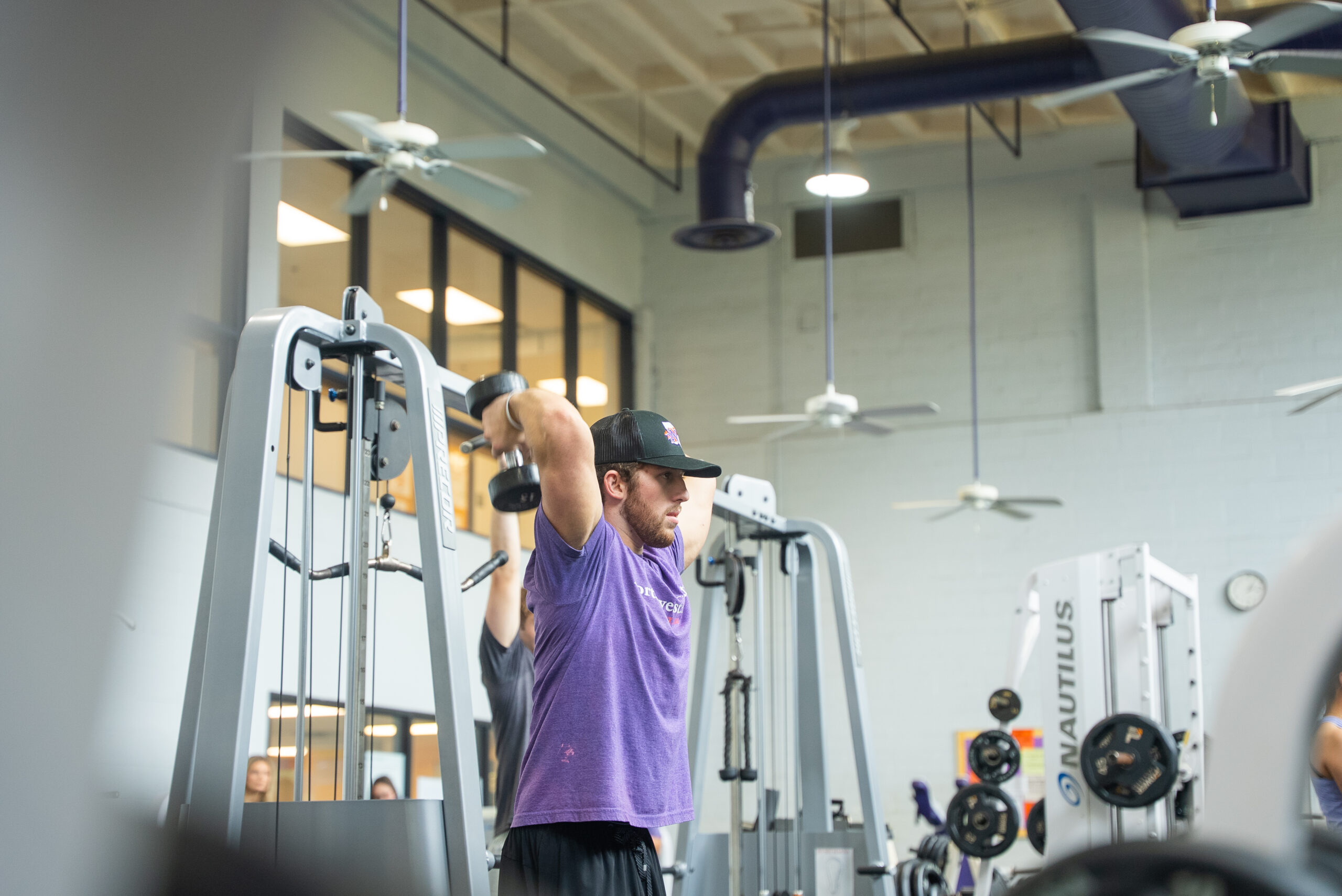 NSU student lifting weights at the WRAC