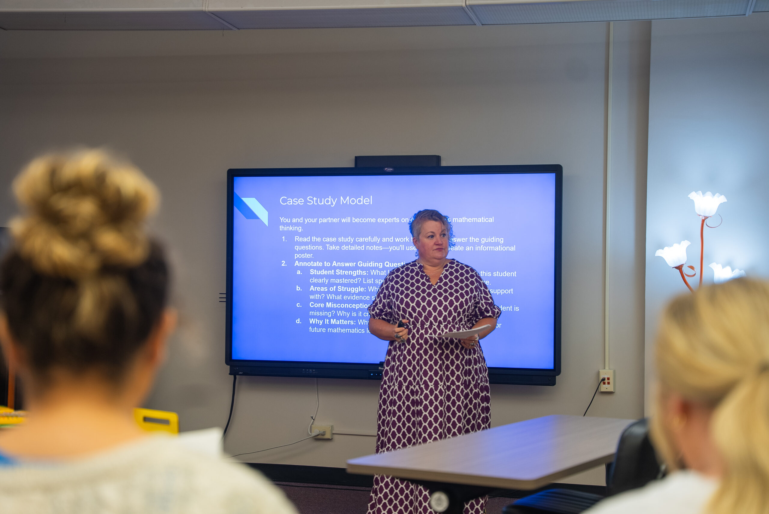 faculty member instructing a classroom of students