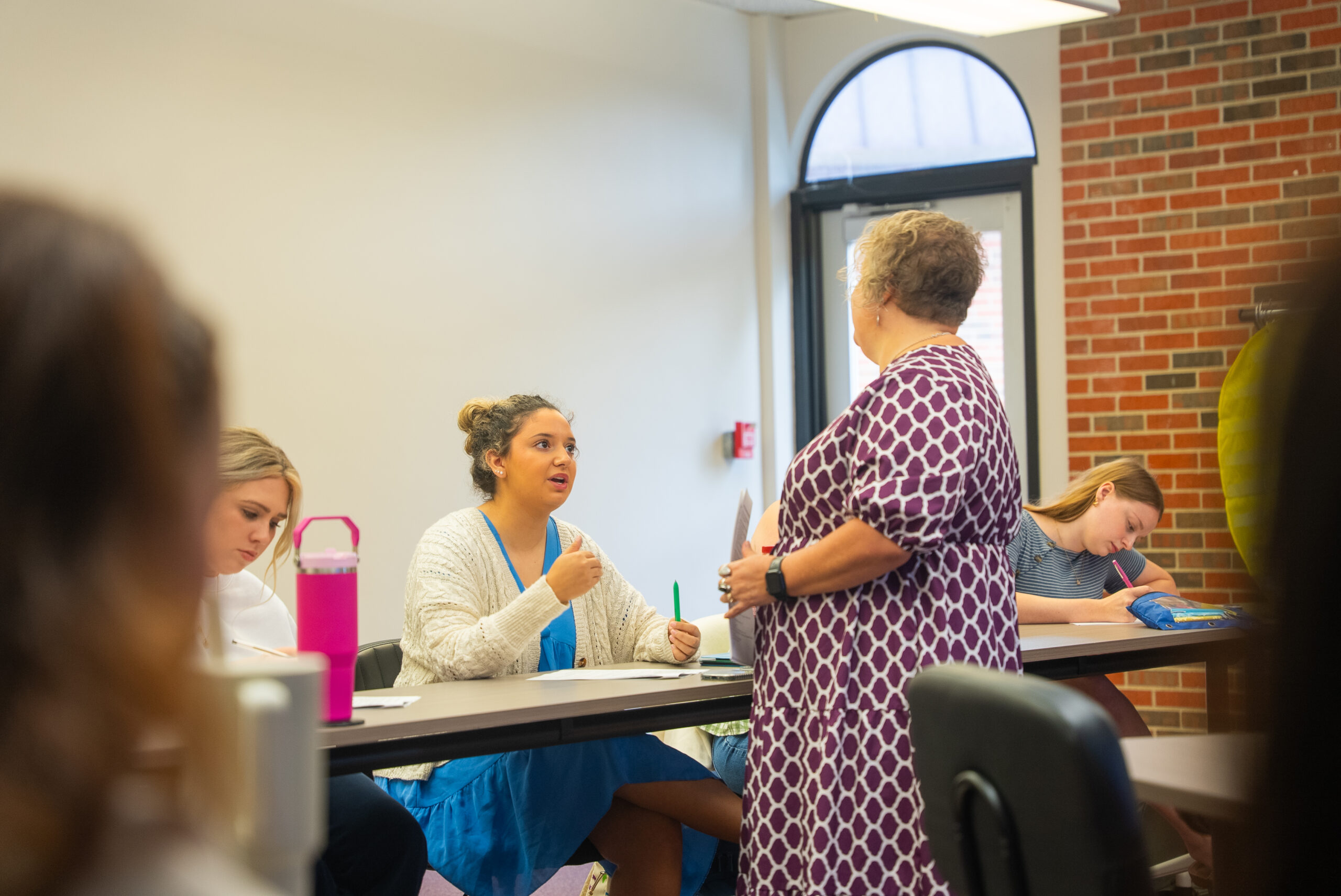 student engaged in a conversation with a student